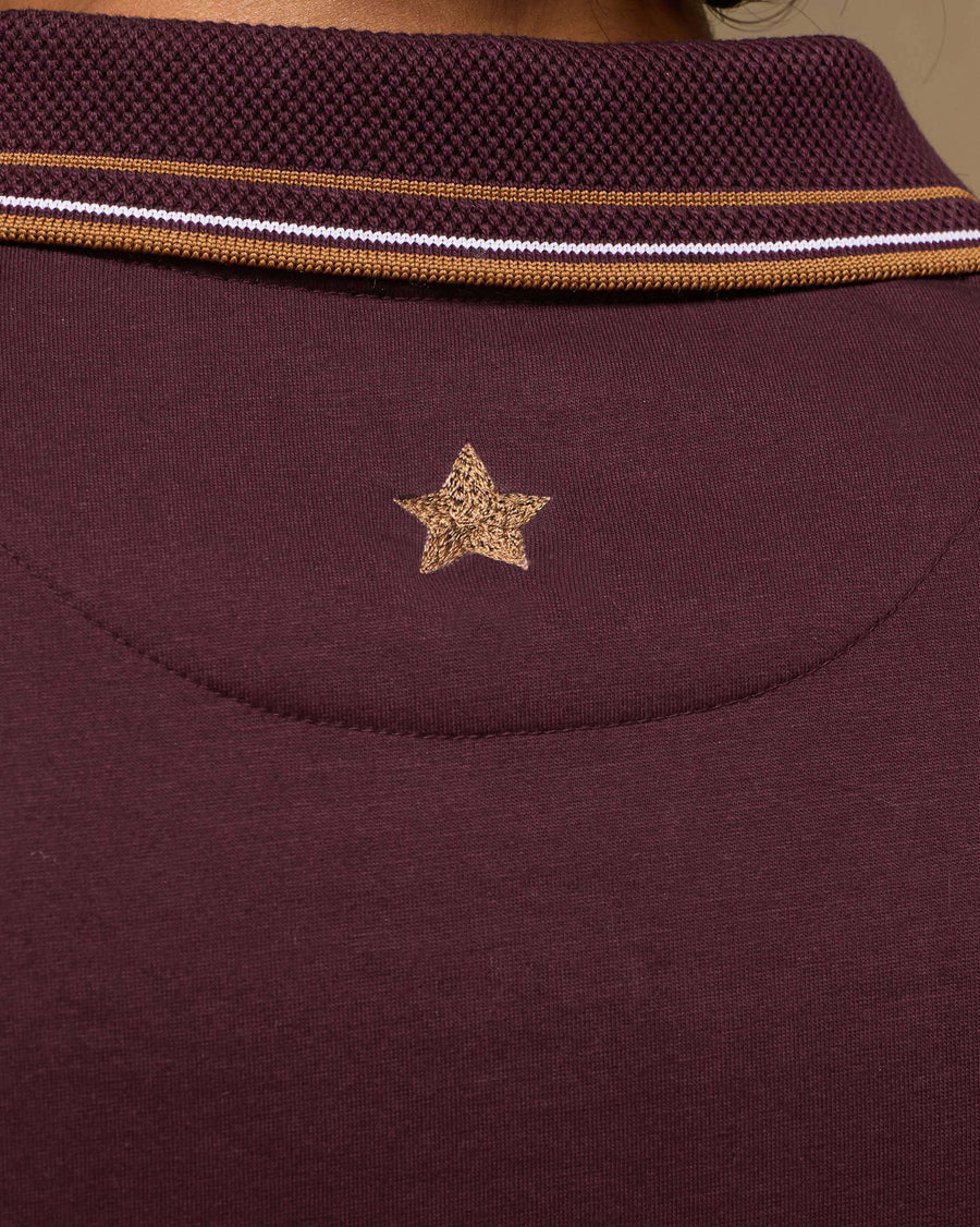 Close-up of the back of the collar of the Stag Polo T-Shirt, with its raised texture, striped tipping and a small star below.
