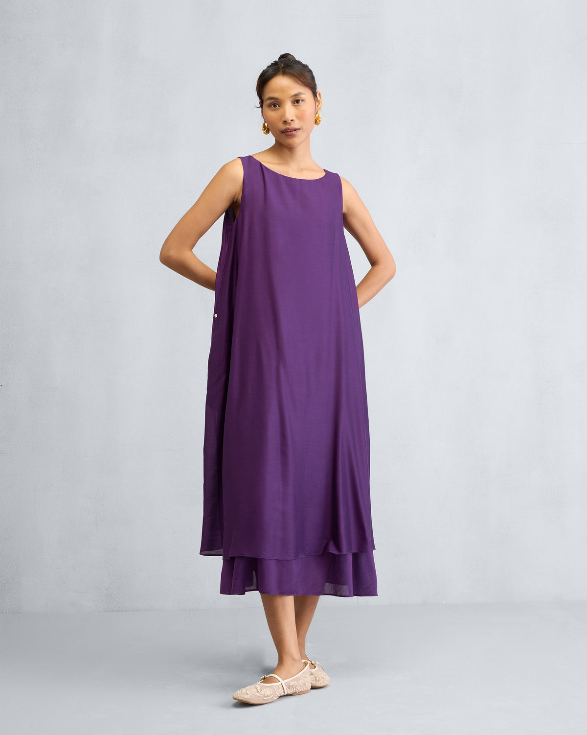 Person wearing a purple Chanderi A-line Double layer dress with a layered hem.