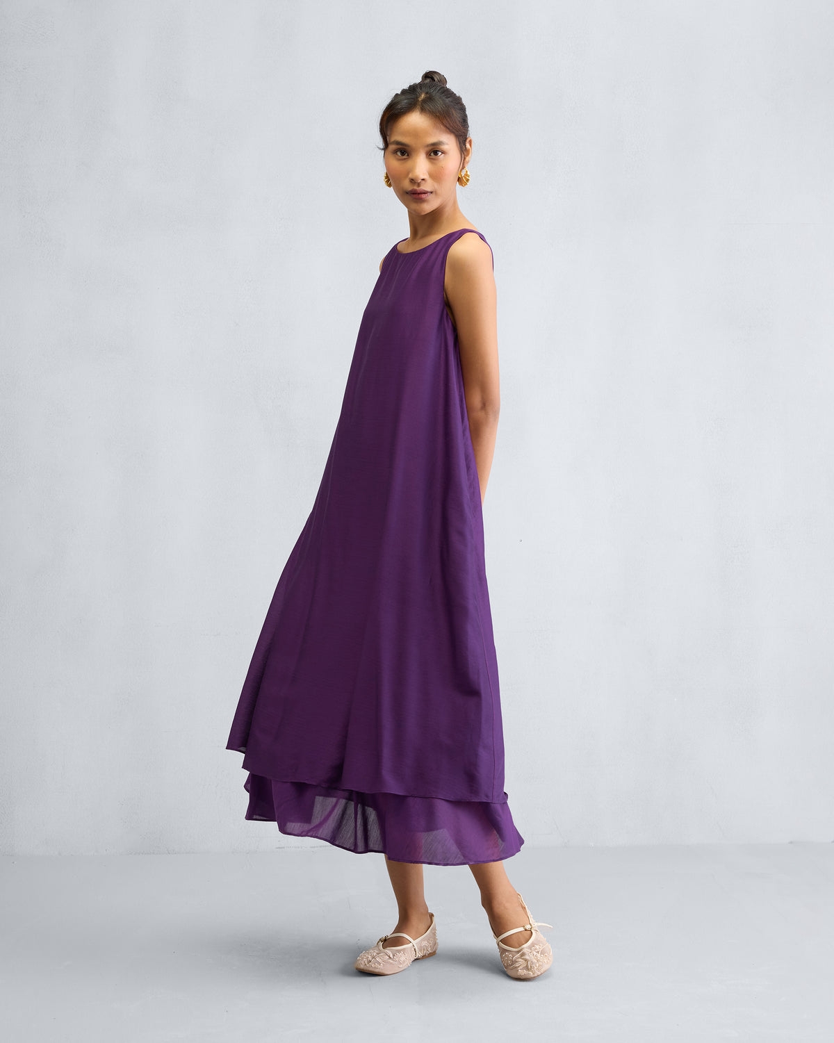 Person turned to the side in a purple Chanderi A-line Double layer dress.