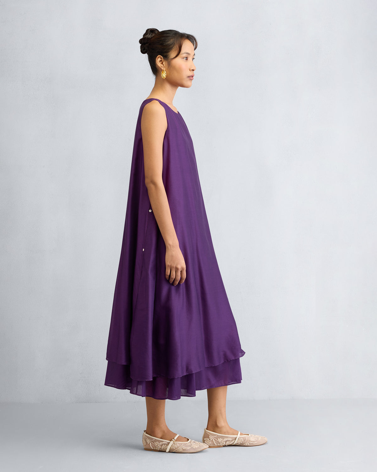 Side view of a purple Chanderi A-line Double layer dress worn by a person.