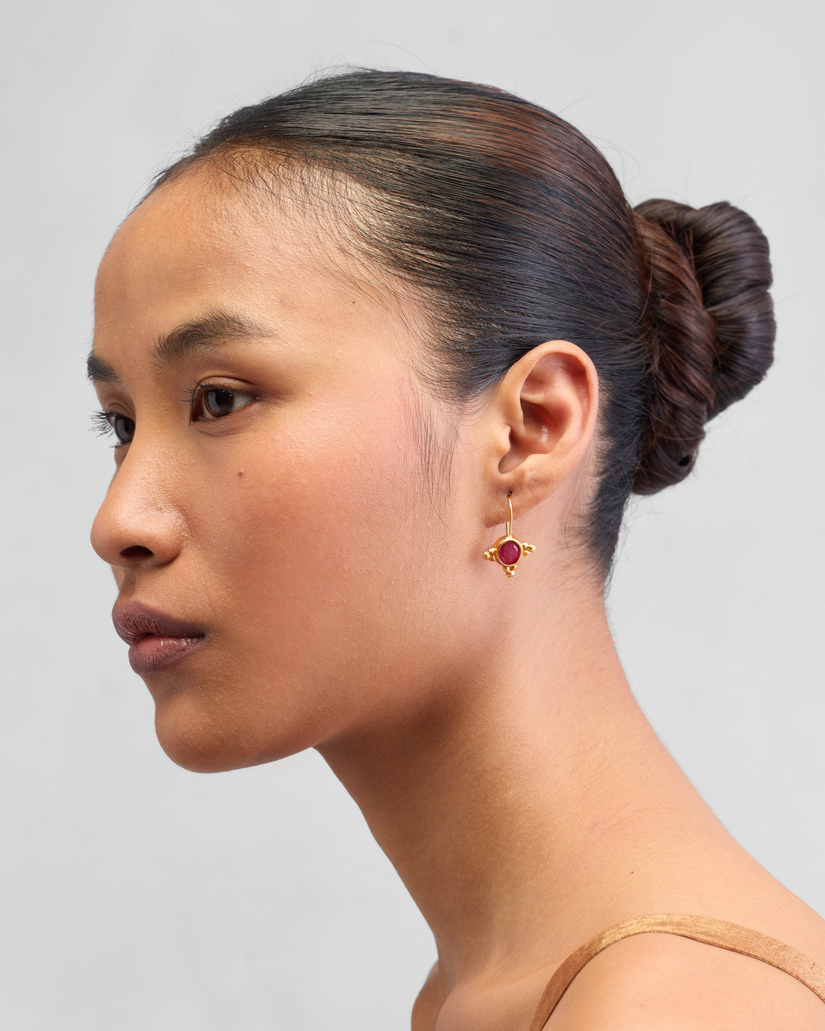 Side view of gold Pink Jade Drops worn on a person.