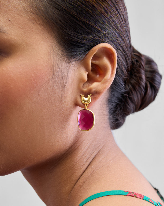 Close-up of Chandphool Earrings worn, with a crescent post and pink stone drop.