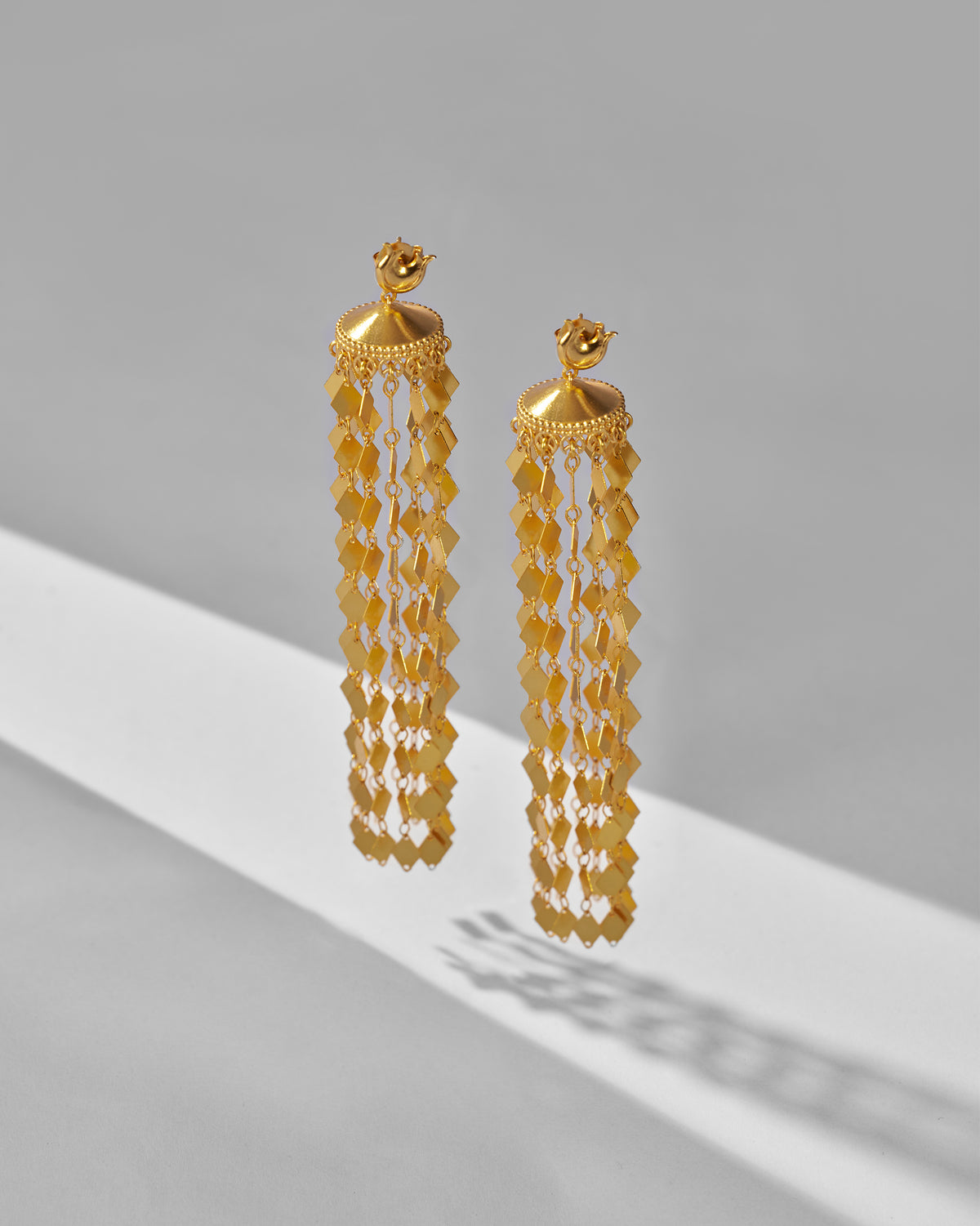 Pair of gold Gulbahar earrings with domed tops and diamond-scale fringe.