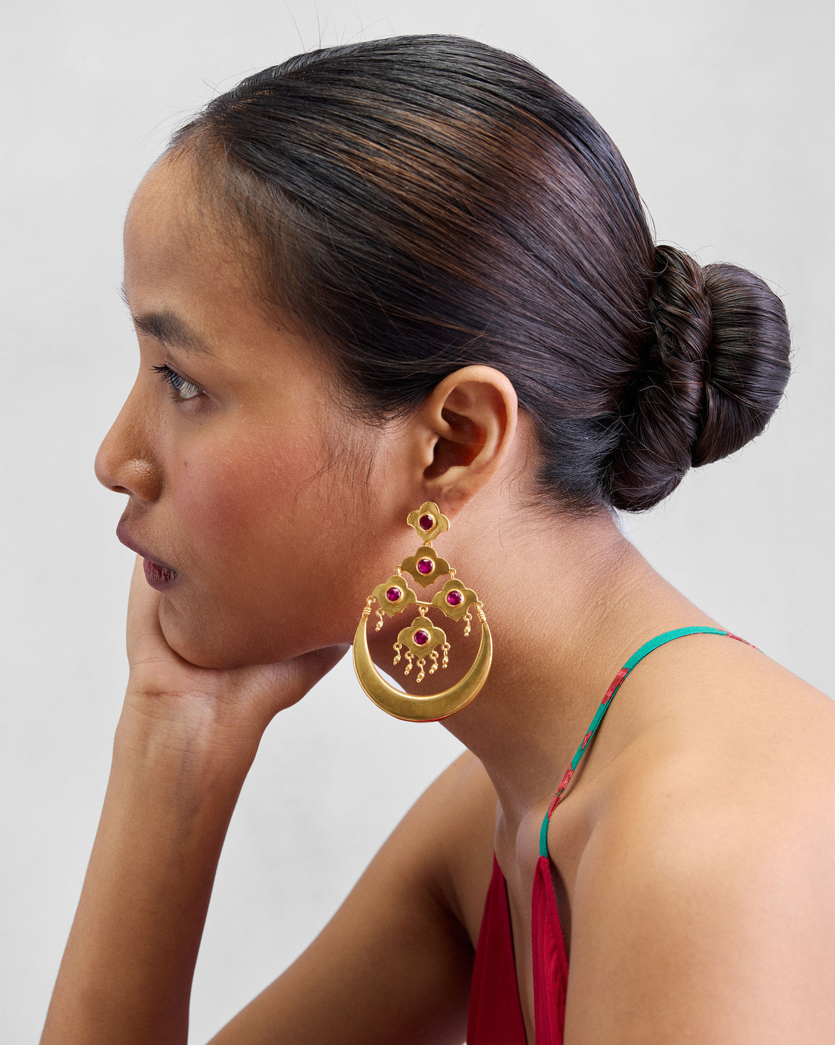 Side profile of a gold Moon Flower crescent earring.