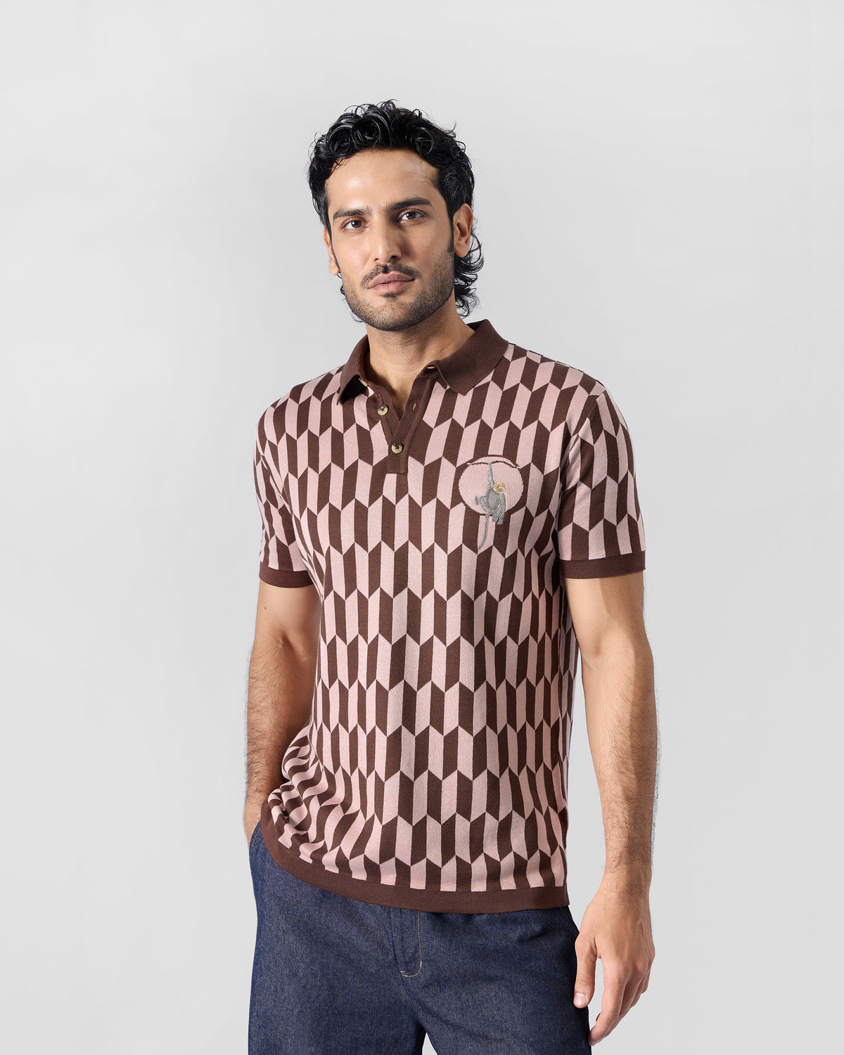 Person wearing a brown-and-pink Langur polo with geometric knit.