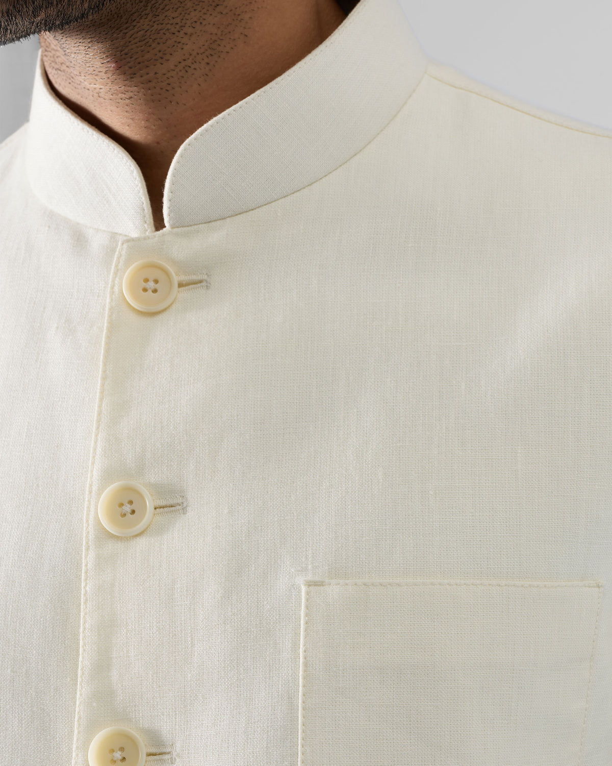 Close-up of the Tahr Bandhgala mandarin collar showing cream placket buttons.