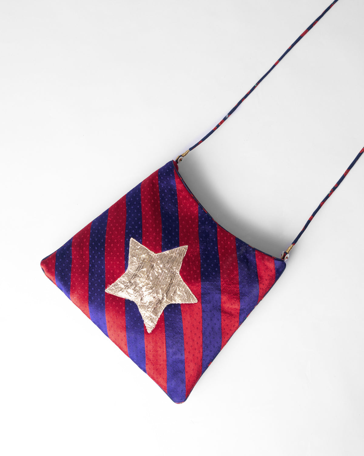 Red and purple Muris Sling with a gold star on the front.
