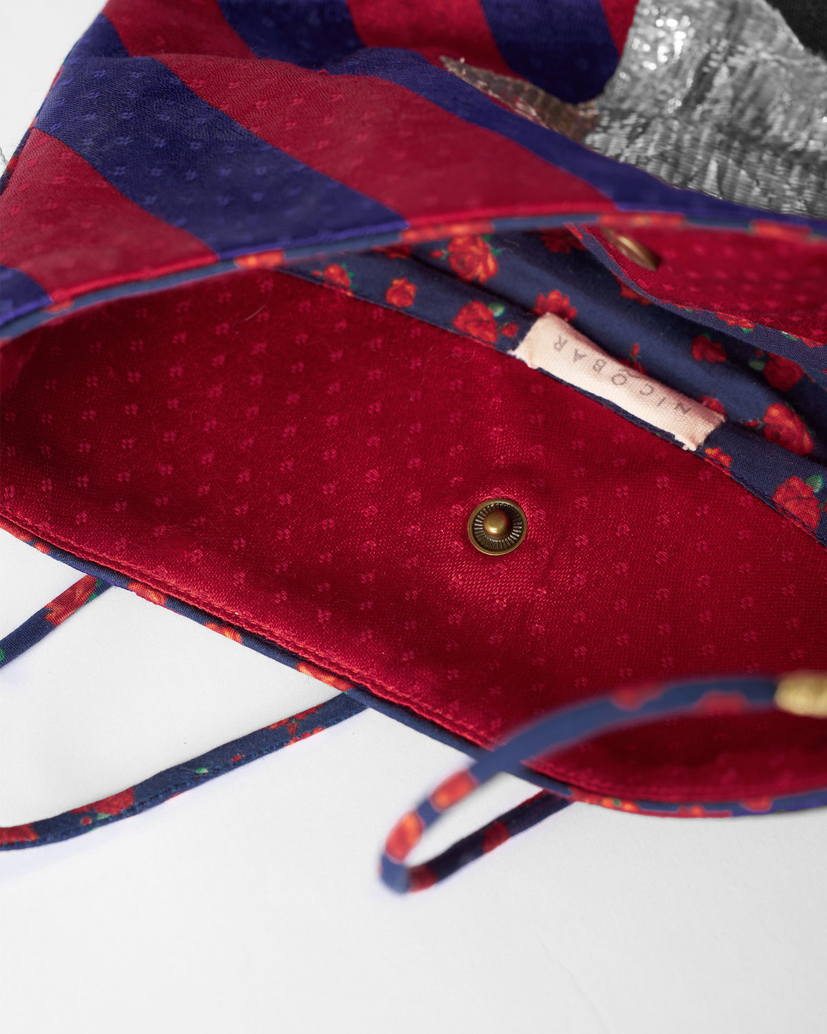 Open red and purple Muris Sling showing a red patterned lining.