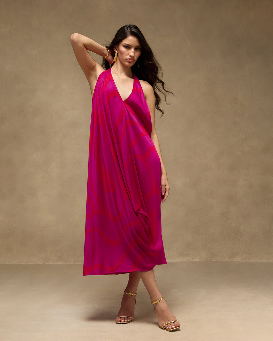 The Shaker Halter Dress with the Yamuna Earrings and gold heels.