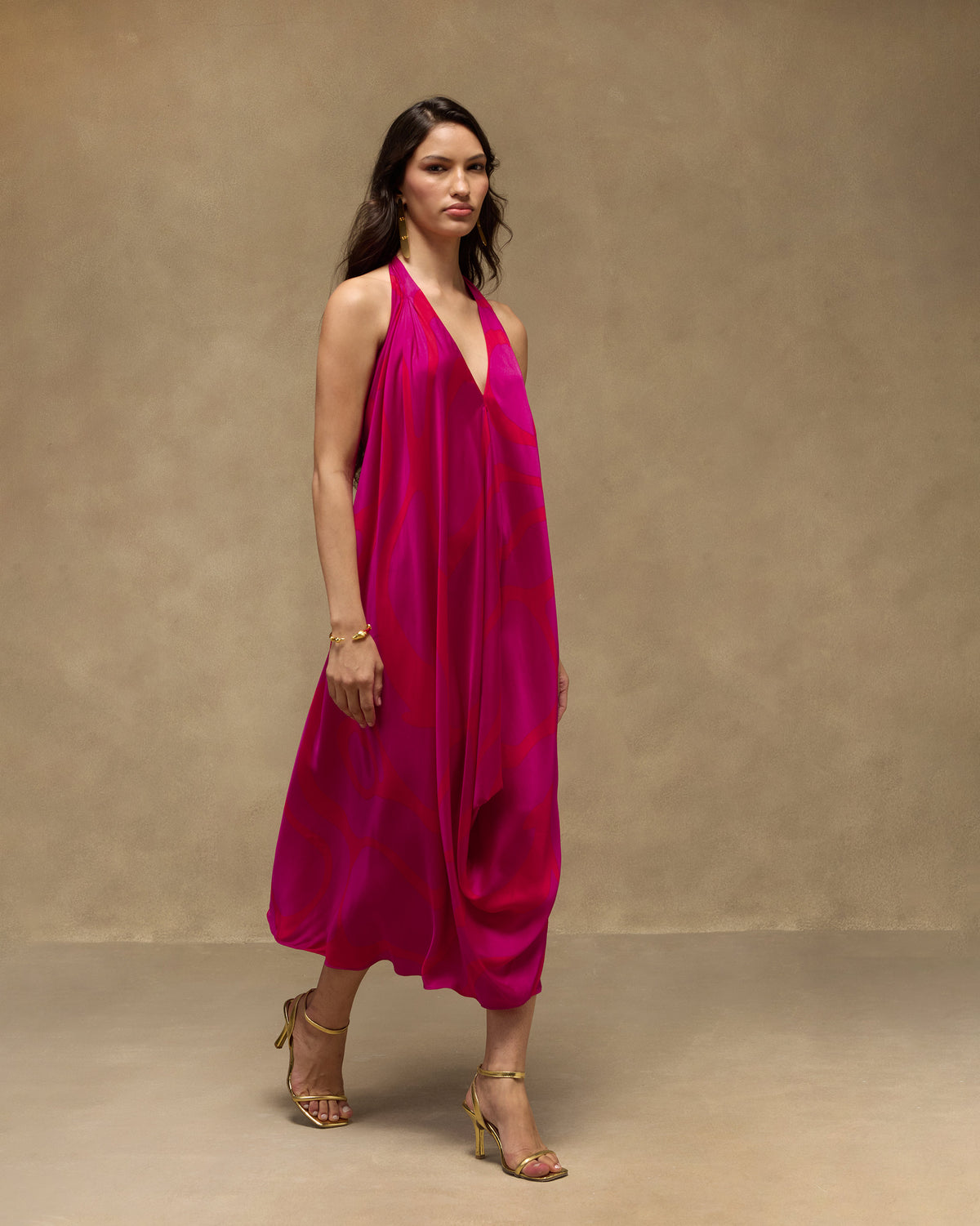 Person wearing a pink and red Shaker Halter Dress with a halter neck.