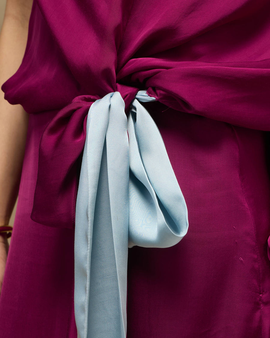 Close-up of the waist of the Fireside Dress, knotted with an ice-blue satin tie.