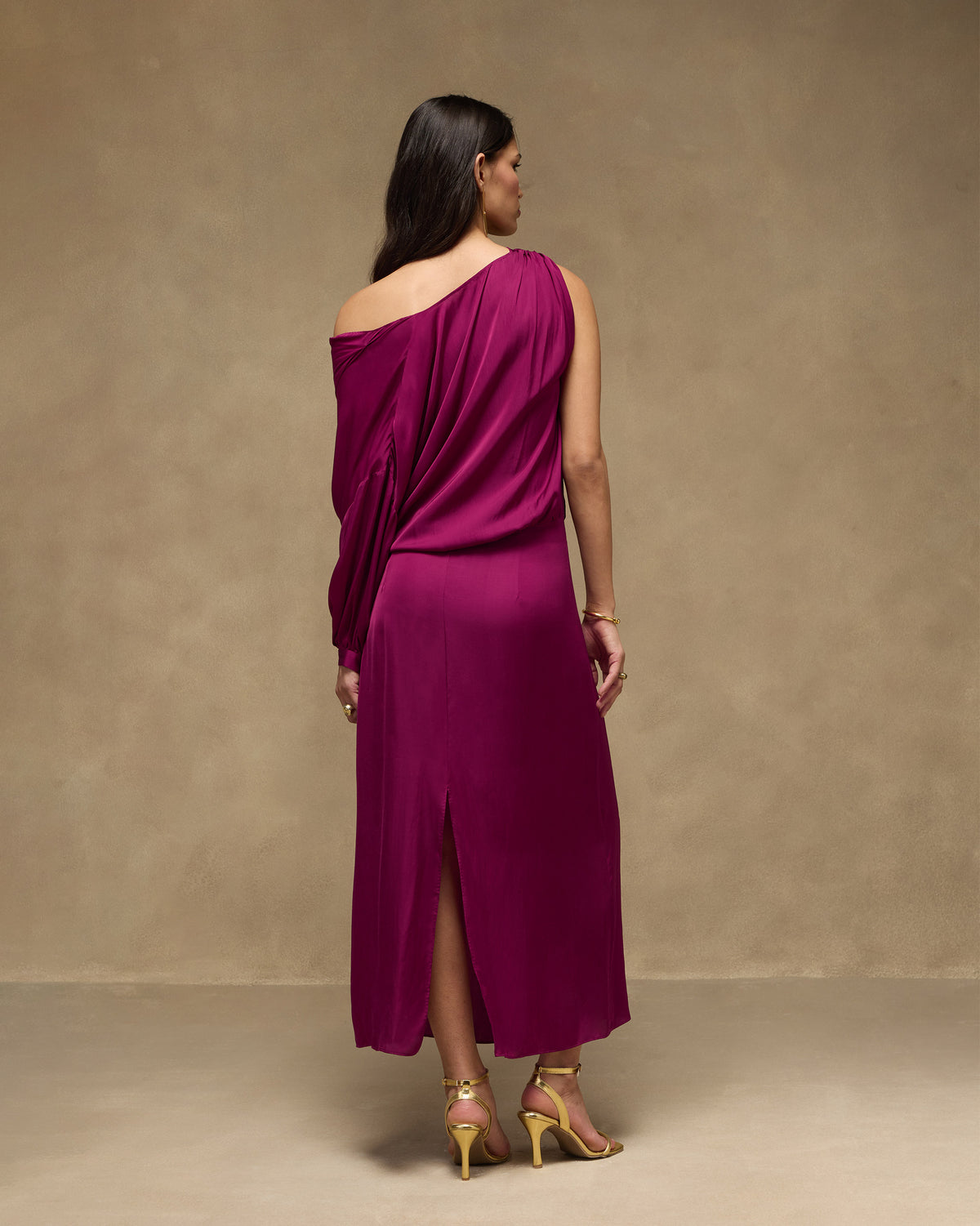 Back of a mulberry one-shoulder Fireside Dress showing a center hem slit.