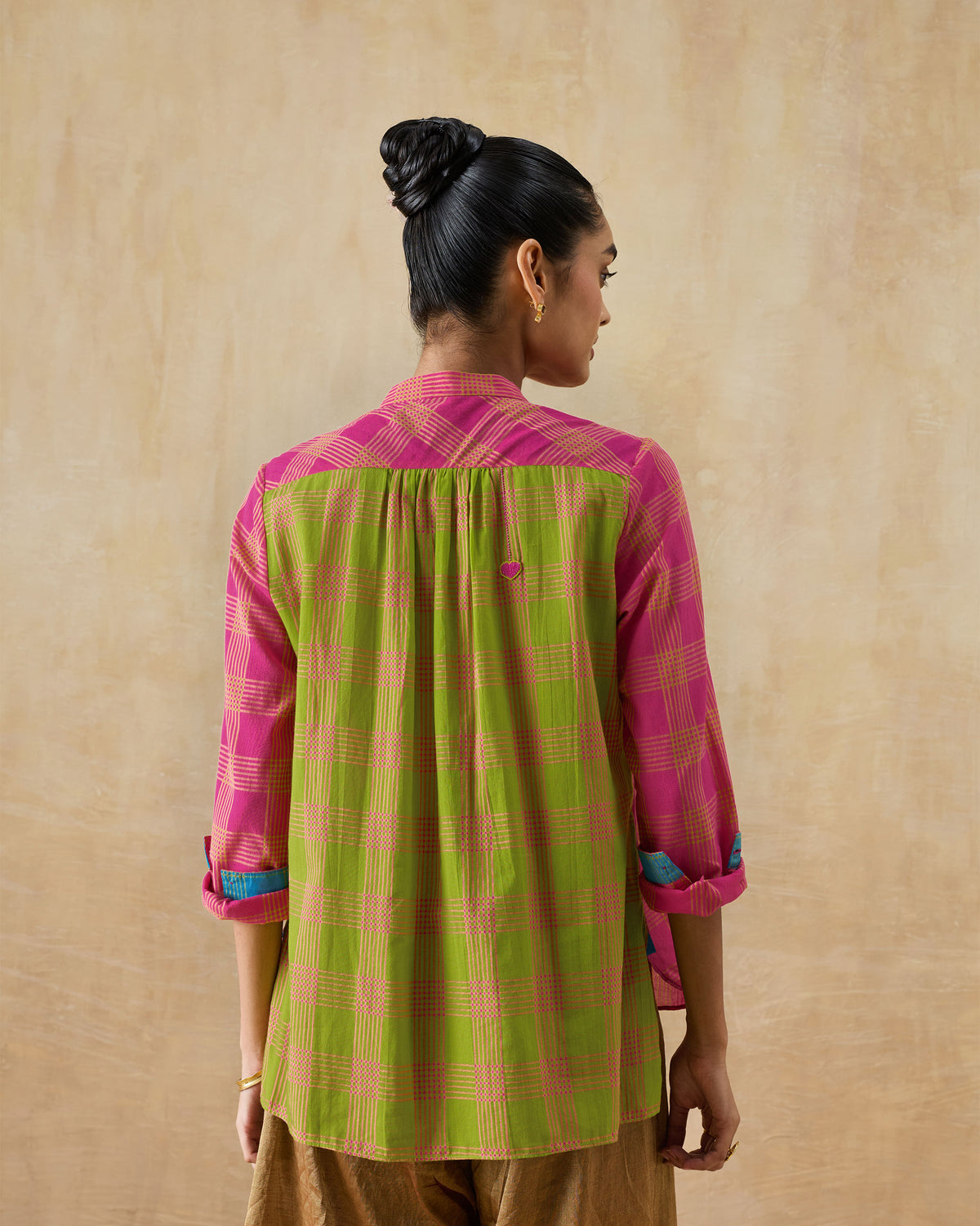 Back of a berry and lime mandarin collar top with a green panel and pink heart.