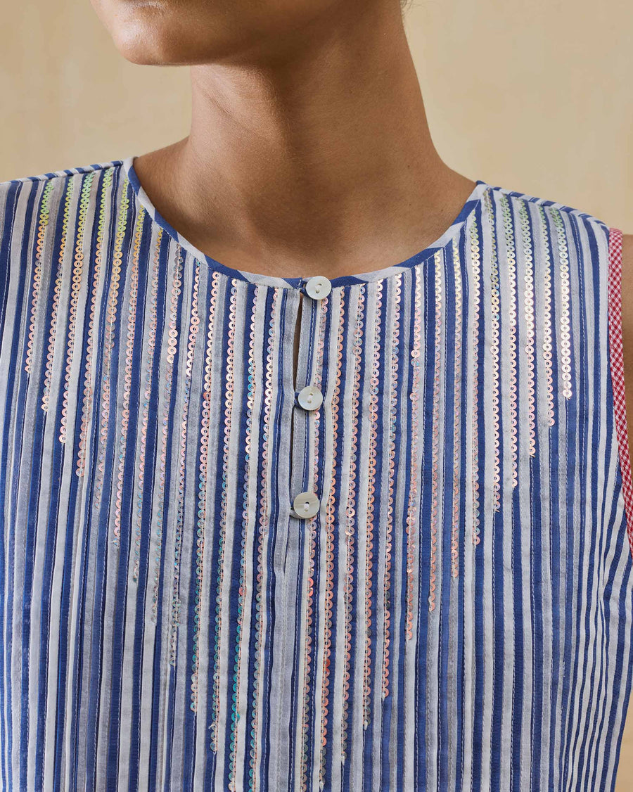 Close-up of the neckline of the Sundowner Top, with sequins following the pintucks and ivory shell buttons.