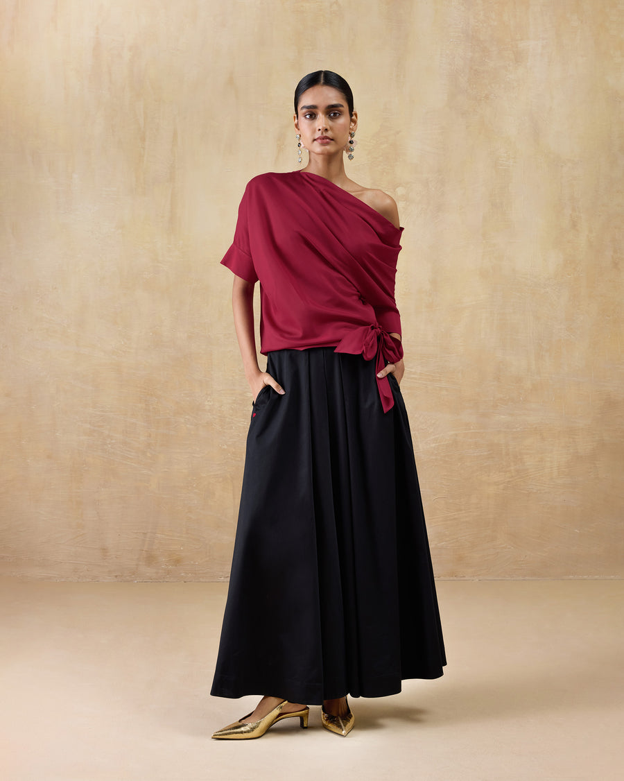 The Tokyo Off-Shoulder Top worn with black and gold heels.
