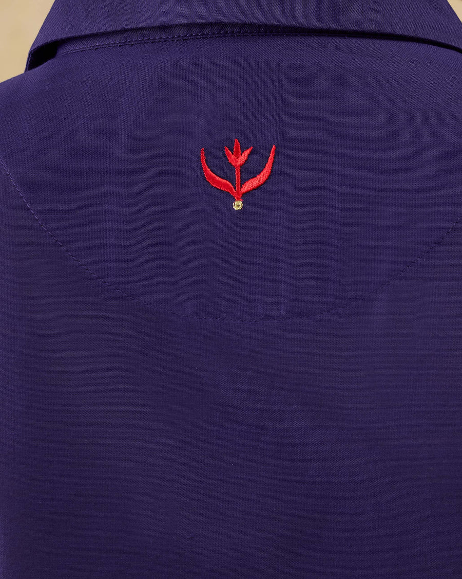 Close-up of the red tulip embroidery with a gold zari dot on the back of the Tuxedo Shirt.