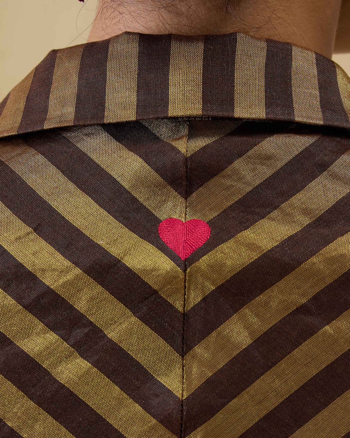 Close-up of an Areva Dress back showing a pink embroidered heart.