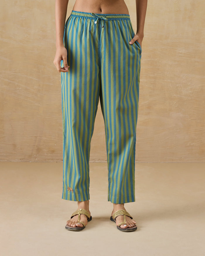Person wearing aqua striped Arzoie pants with a drawstring waist.