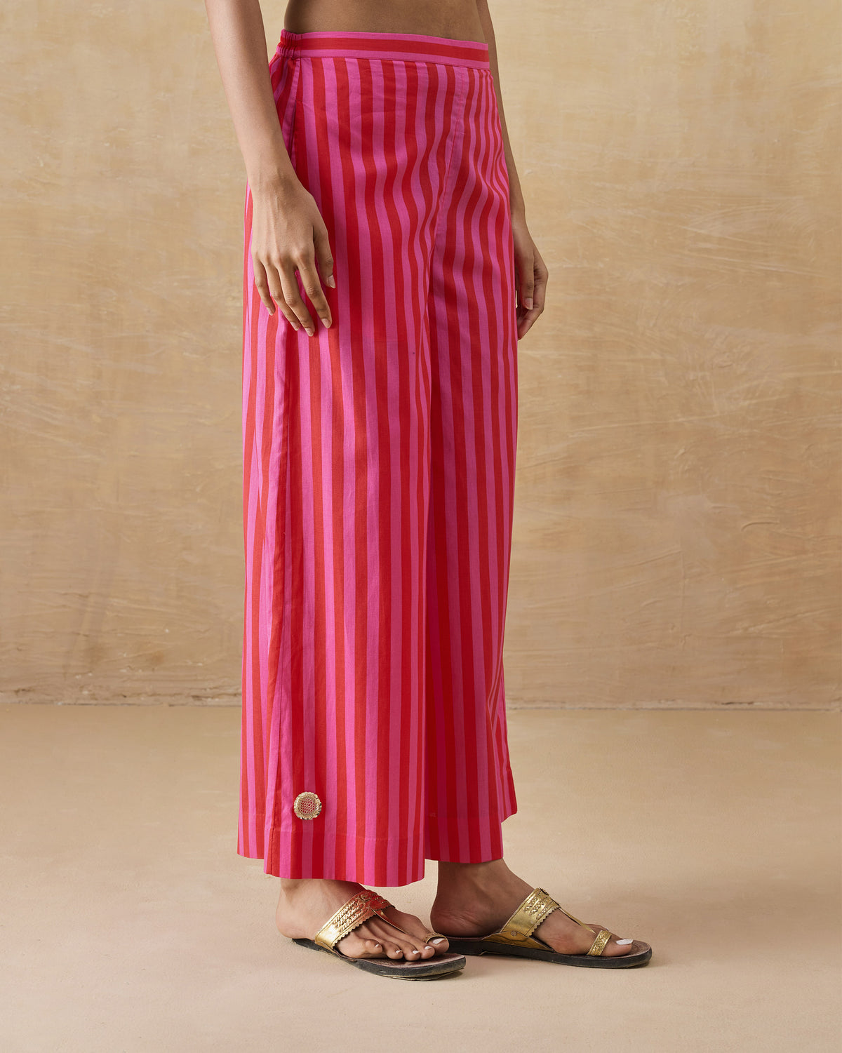 Red and berry striped Basic pyjamas worn at a three-quarter angle.