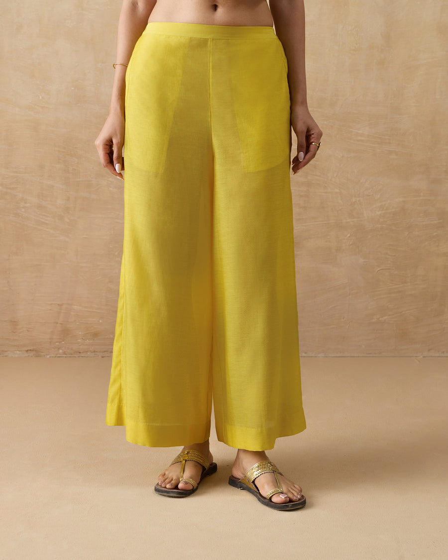 The Basic Pyjamas, wide A-line chartreuse cotton silk pyjamas, worn with flat sandals.