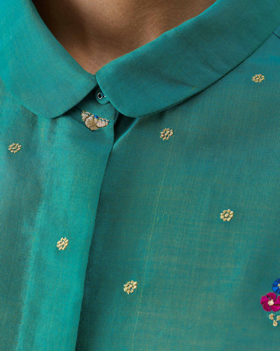 Close-up of the collar of the Boxy Shirt, with small embroidered flowers on aqua cotton silk.