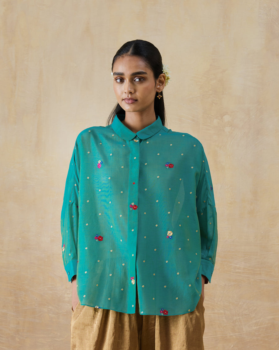 The Boxy Shirt buttoned at the collar, its embroidery catching the light.