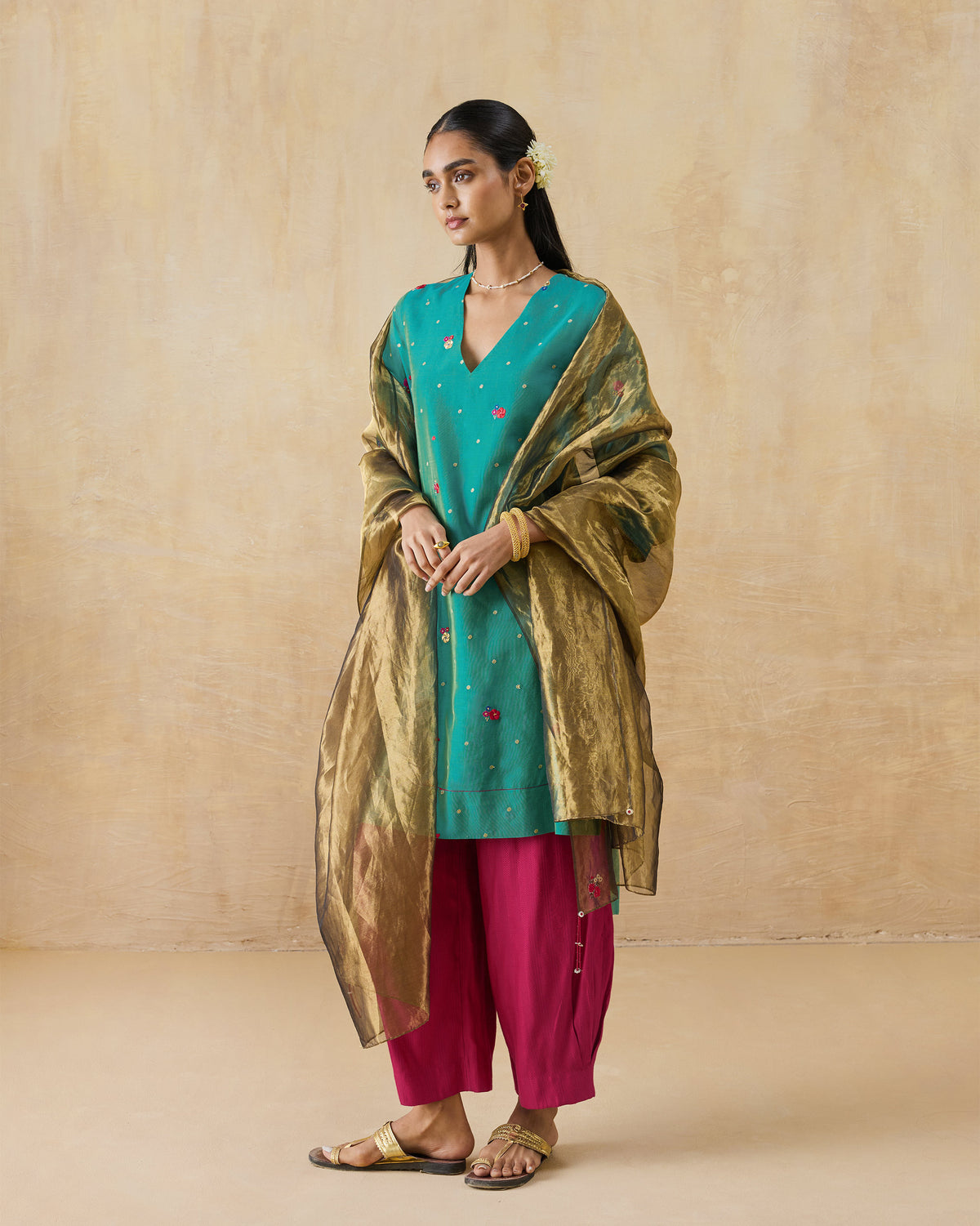 Person wearing an aqua Twilight kurta with floral embroidery.