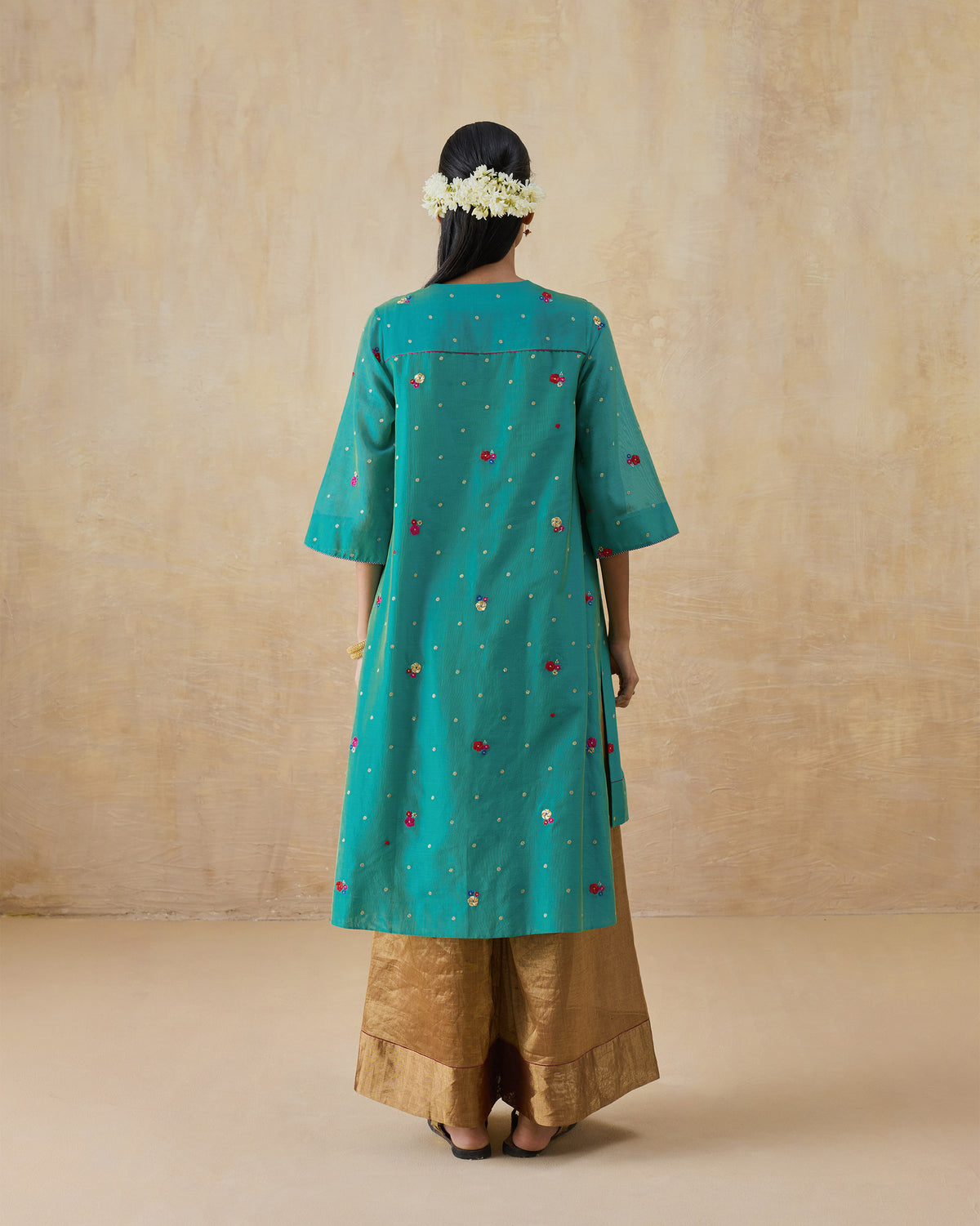 Back of an aqua Twilight kurta with floral embroidery.