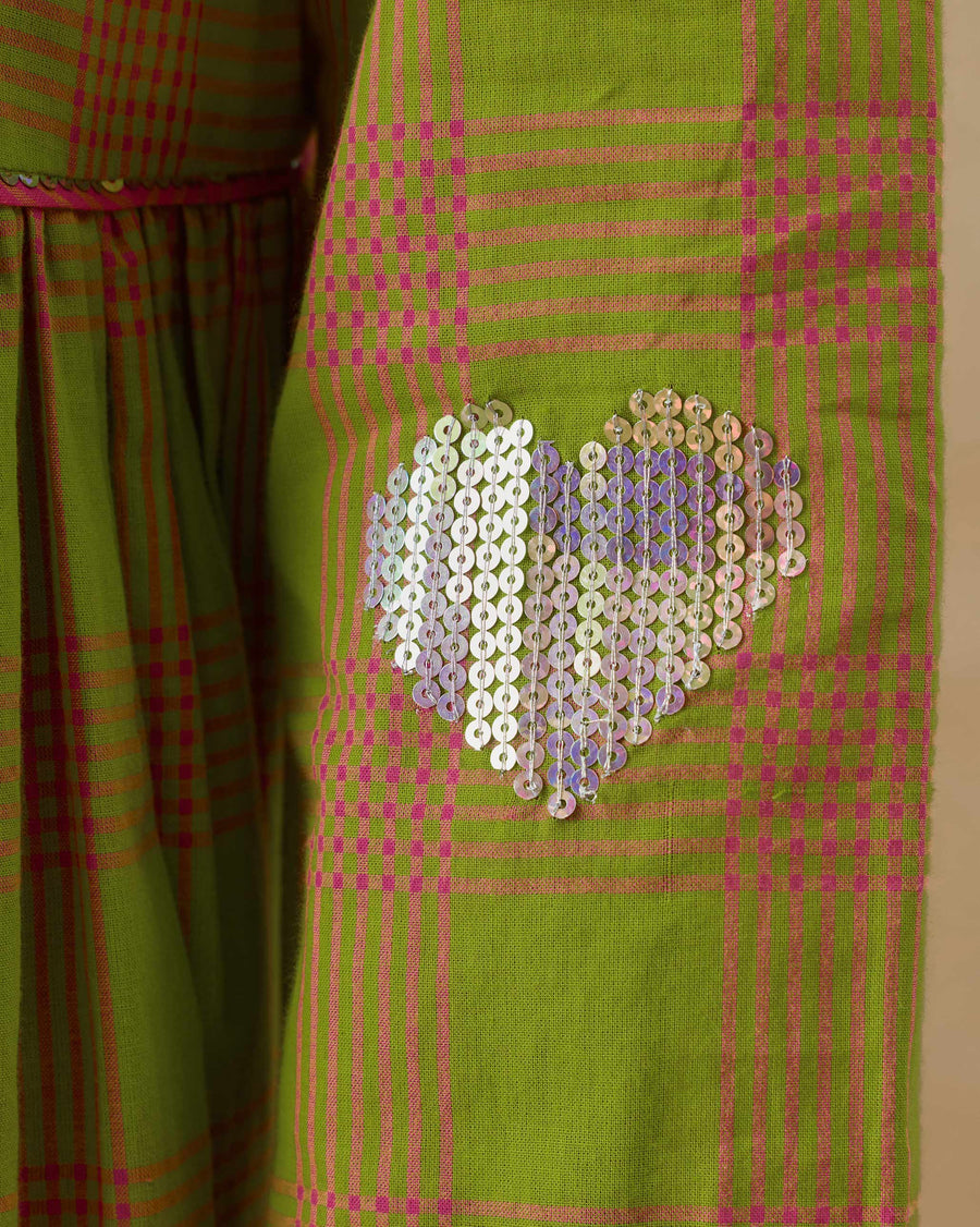 Close-up of the rainbow sequin heart on the sleeve of the Pintuck Kurta.