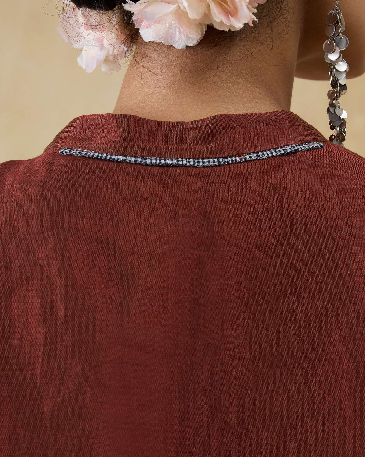 Close-up of the scarlet red kaftan back neck with checked trim.
