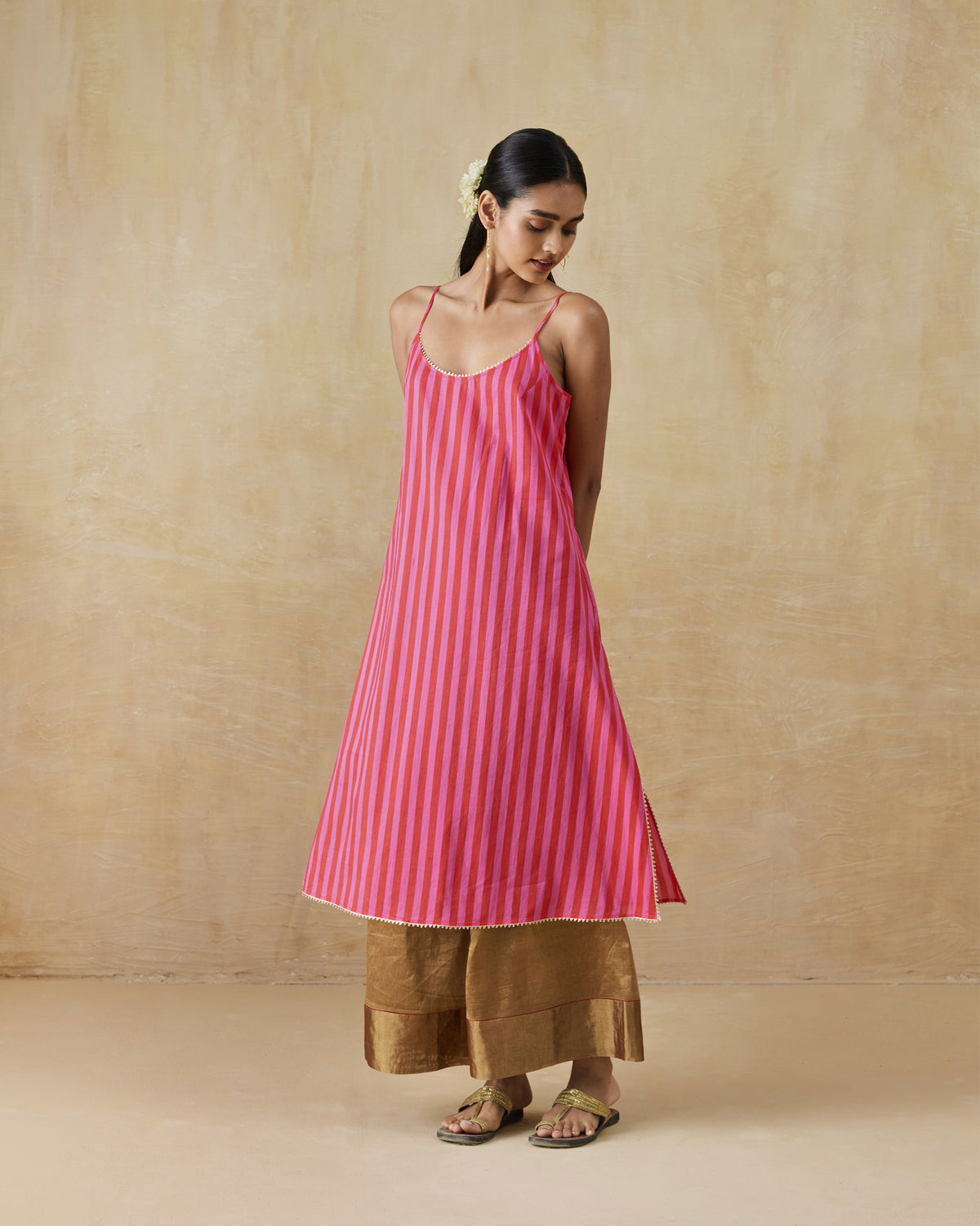 Person wearing a red and berry striped Mist Camisole.