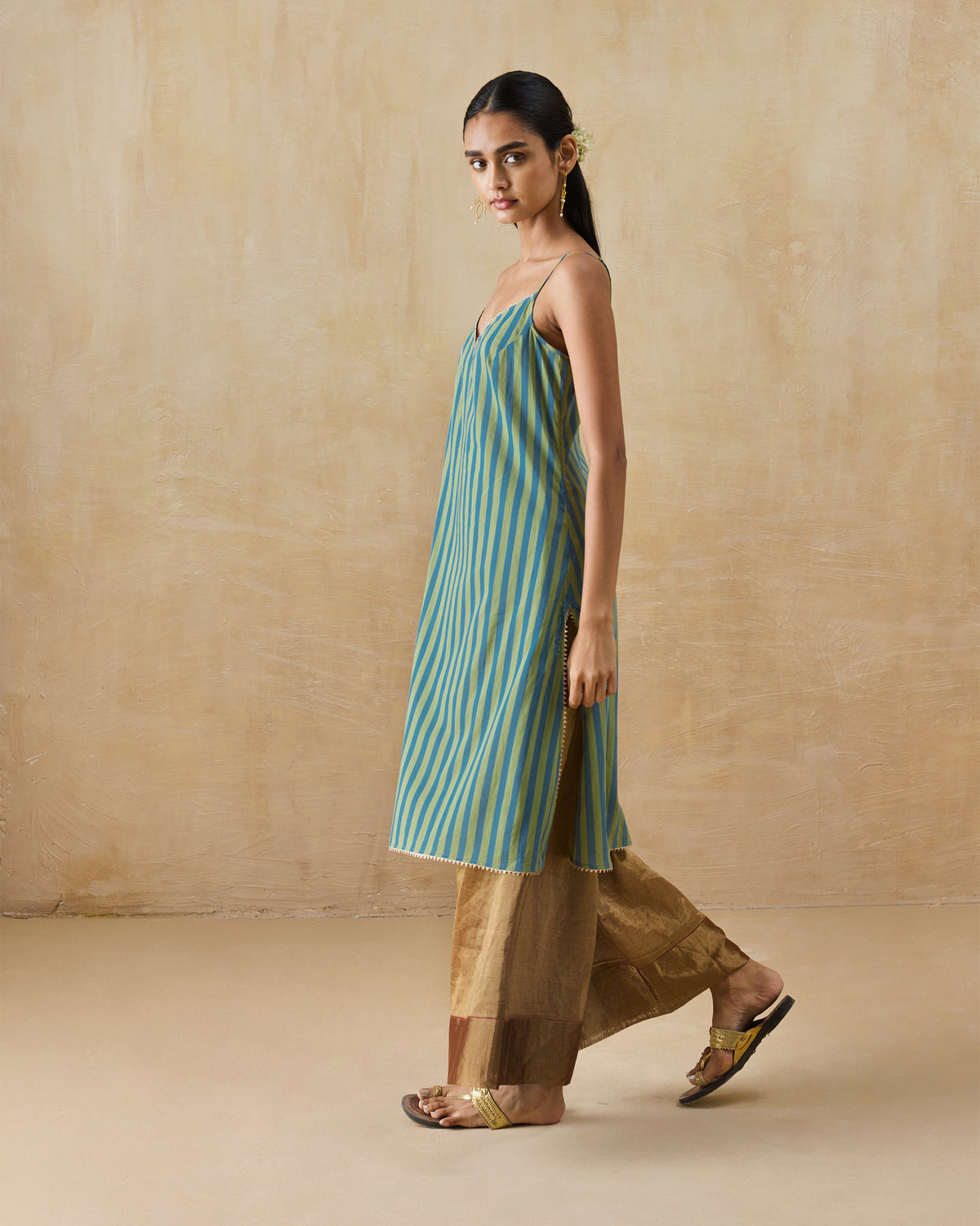 Side view of a green and blue striped Mist camisole.