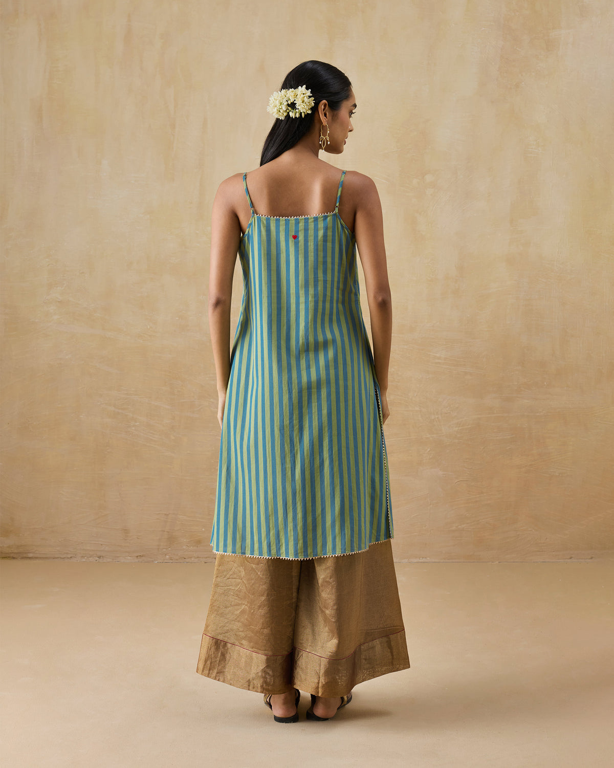 Back of a green and blue striped Mist camisole with a red heart.
