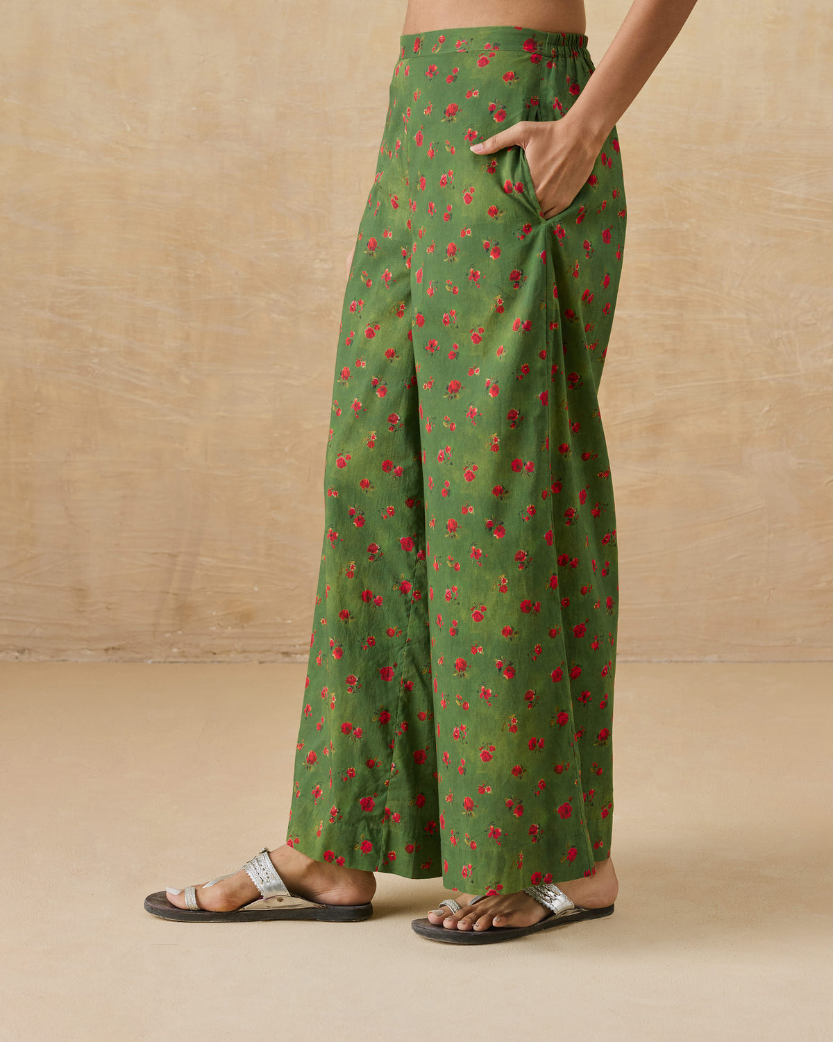 Side view of olive green Basic pyjamas with a rose print and side pocket.