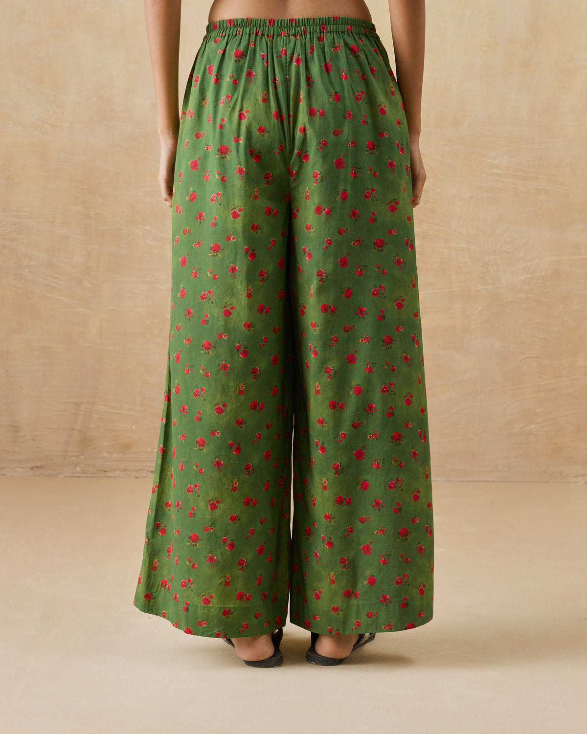 Back of olive green Basic pyjamas with a rose print and elastic waist.