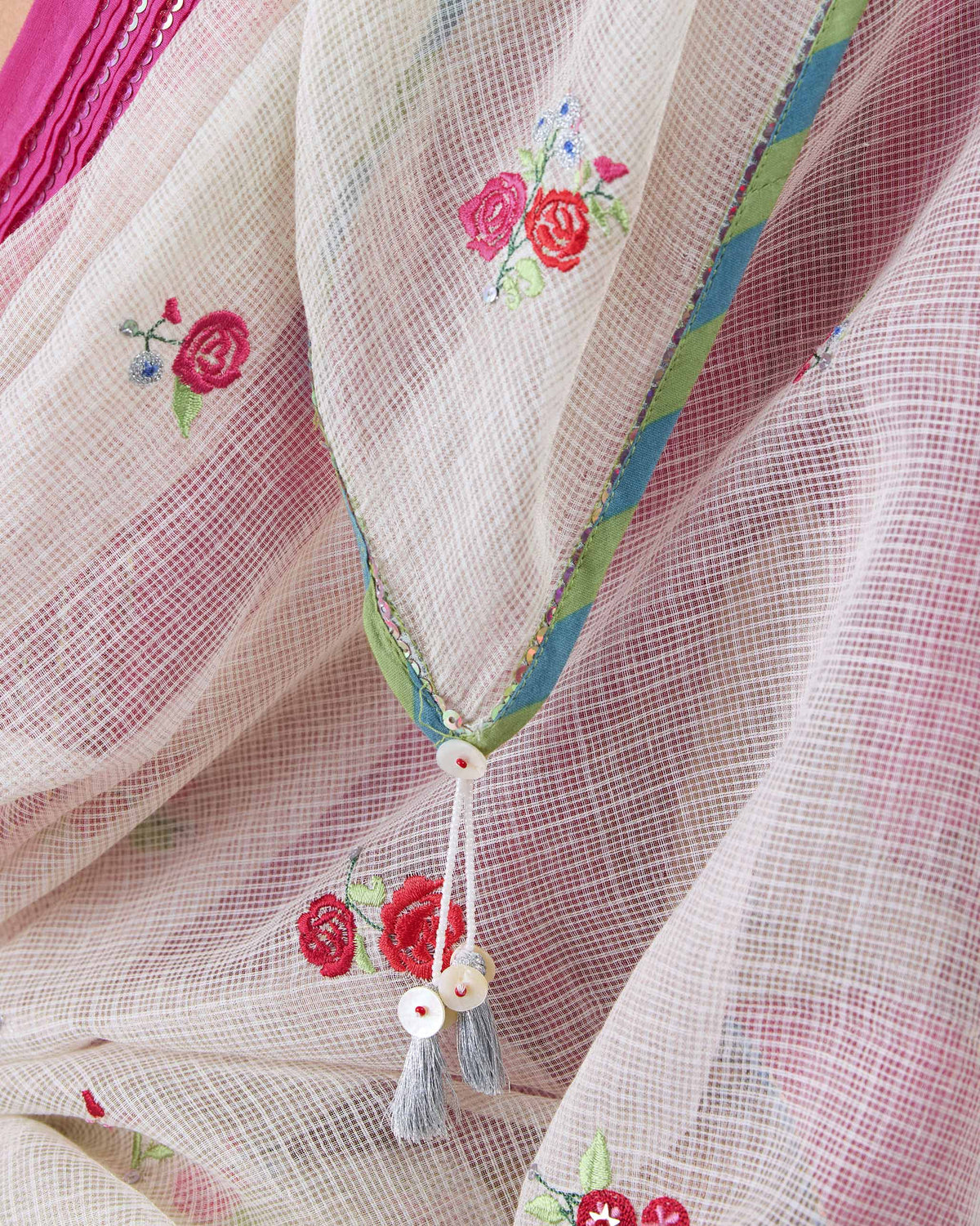 Close-up of a Swish dupatta showing embroidered roses and tasselled ends.