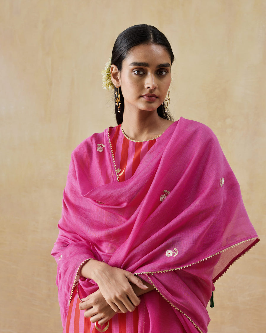 The Bubbly Dupatta, a fuchsia cotton silk dupatta with gota edging, draped over both shoulders.
