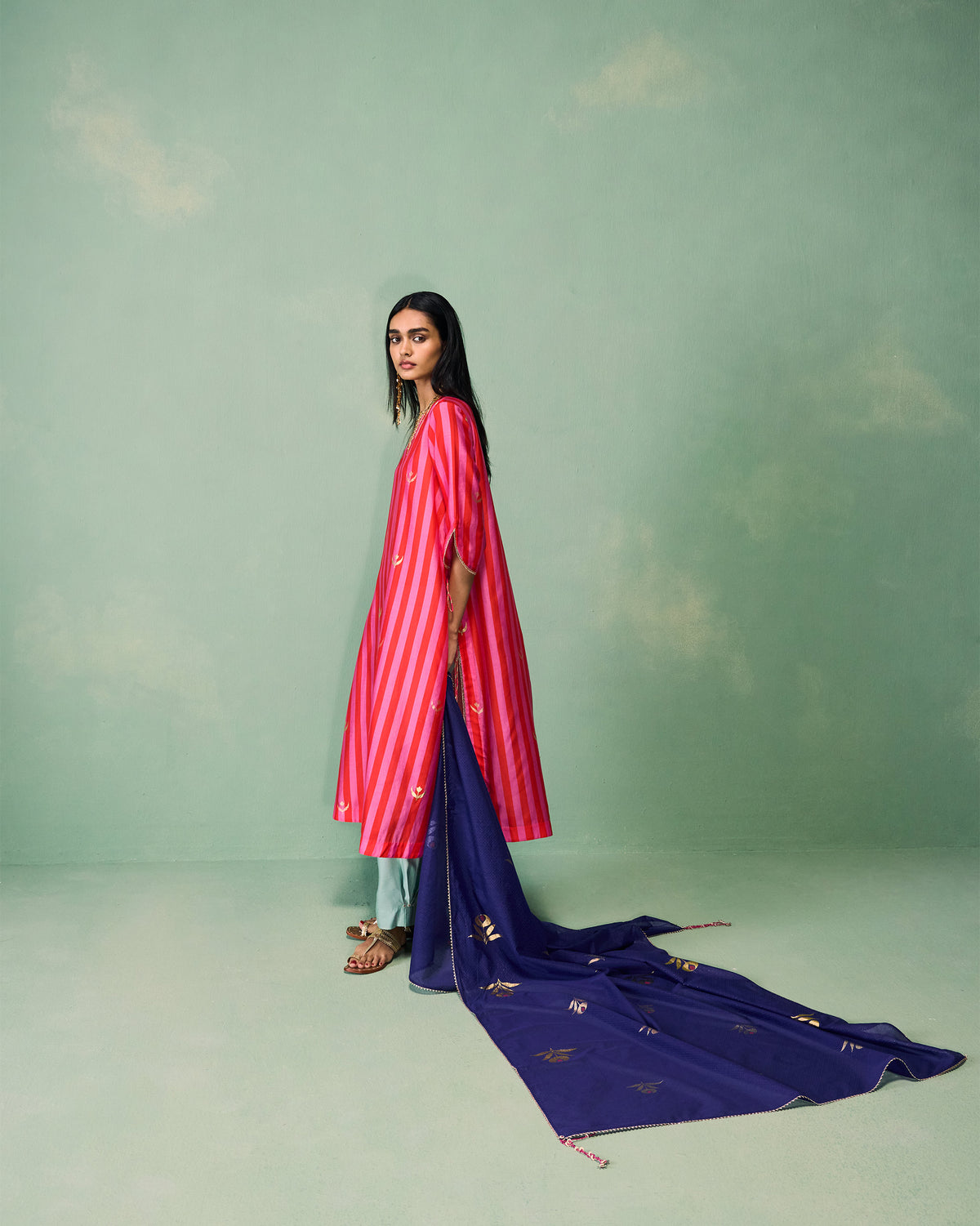 Side view of a Buzz dupatta trailing behind a person.