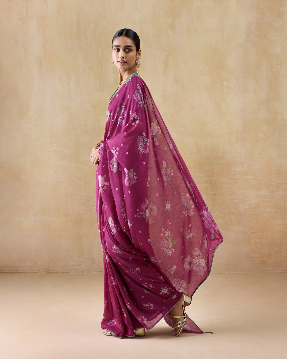 Berry Speckle sari with a floral pallu draped over the shoulder.