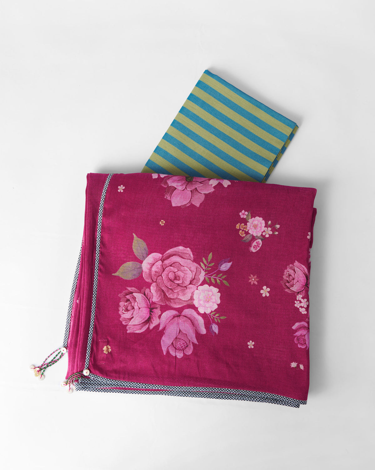 Berry Speckle sari folded flat showing a floral print and checkered border.