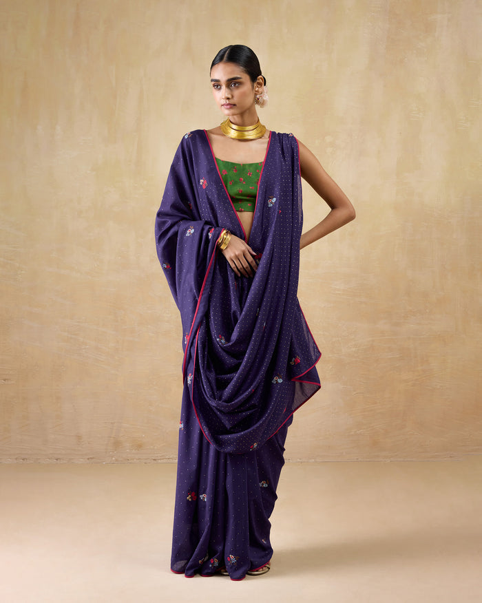Person wearing a purple Midnight Dance Sari with gold dots and floral embroidery.