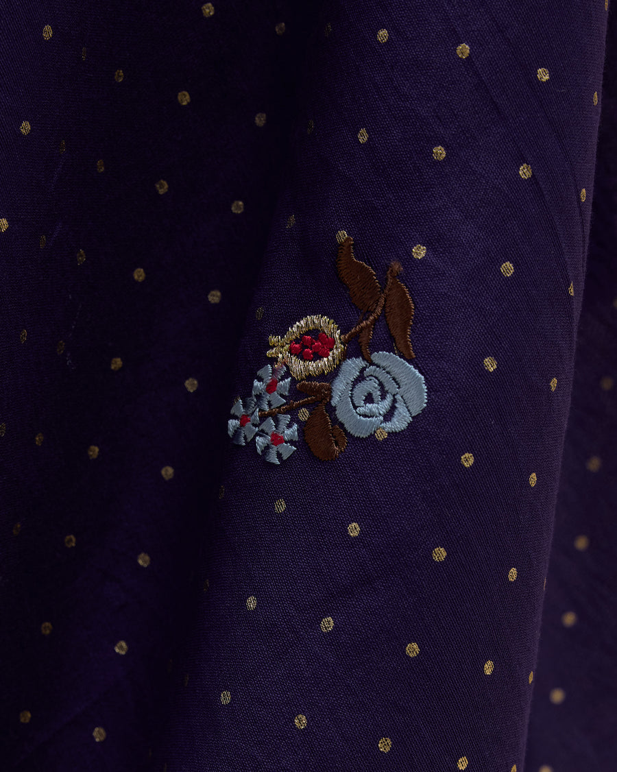 Close-up of the Midnight Dance Sari: an embroidered blue flower over all-over foil dots.