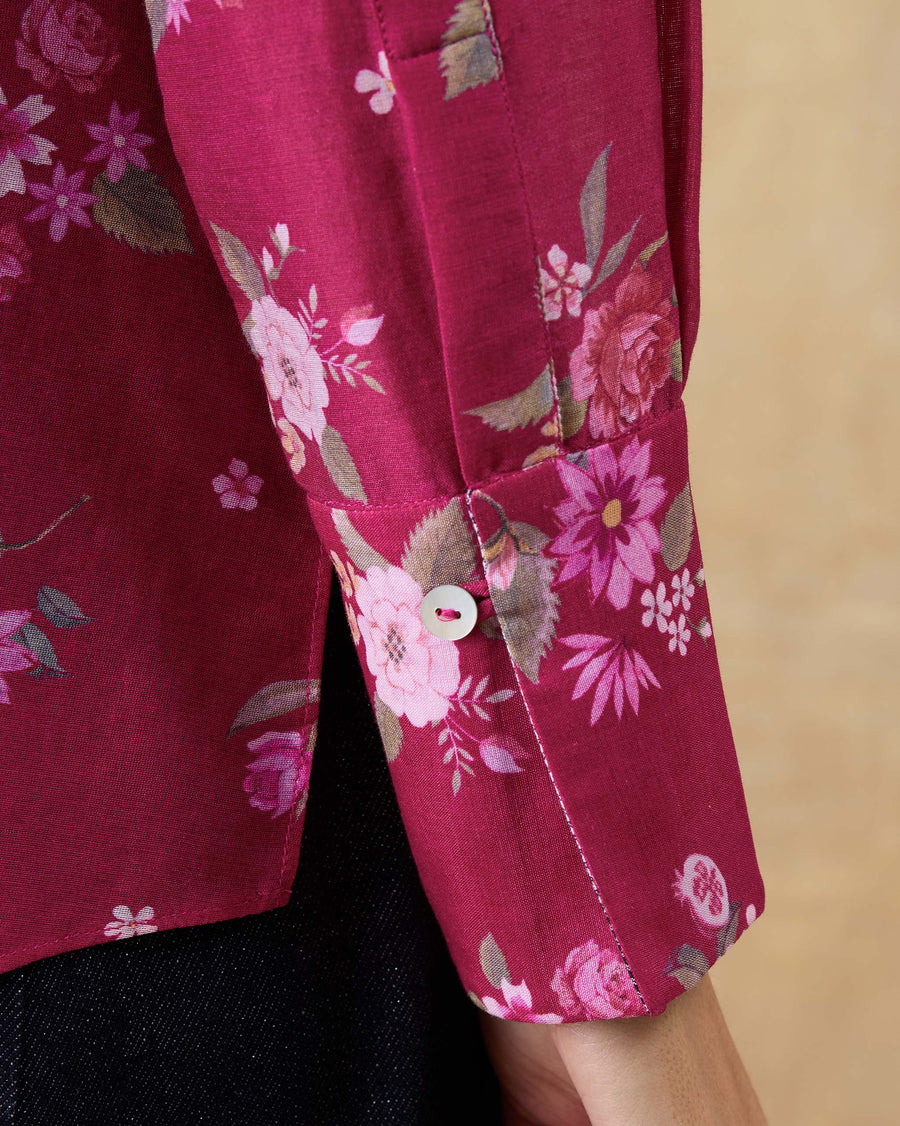 Close-up of the cuff of the Kaveri Ruffle Shirt, showing the Berry Guldasta print and a shell button.