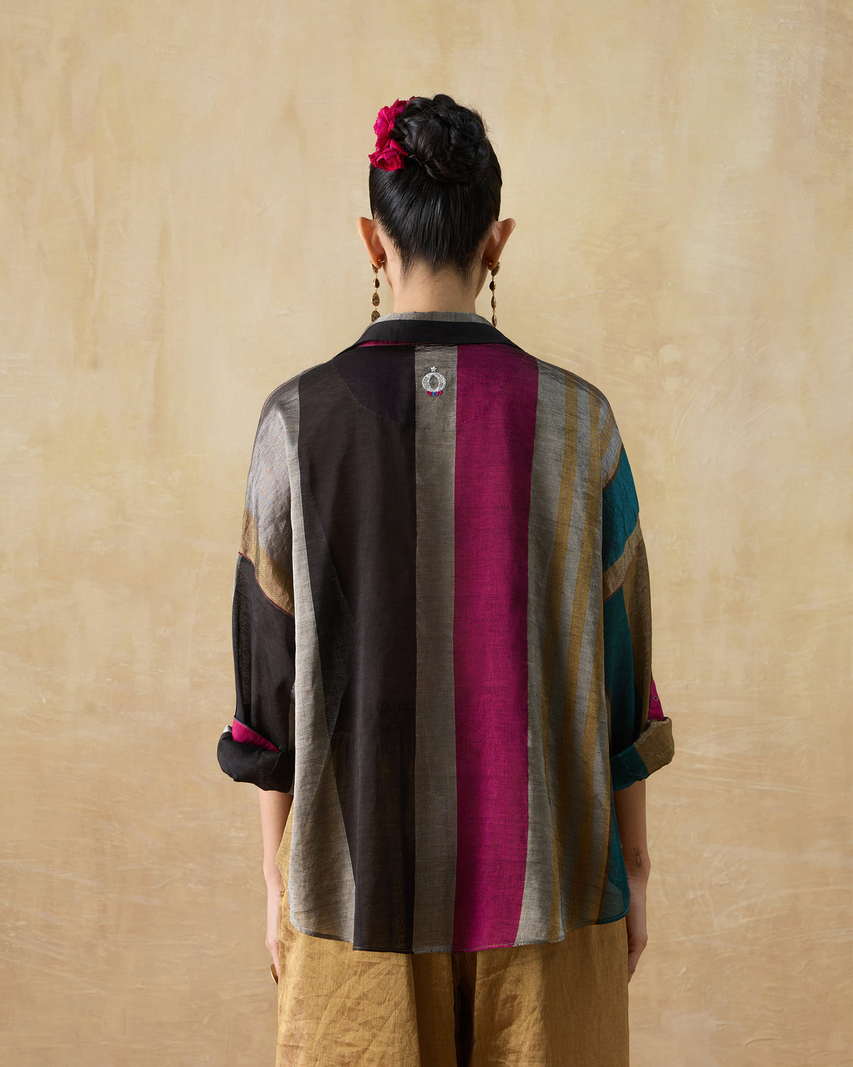 Back of a multicolour metallic Firefly shirt with bold vertical stripes.