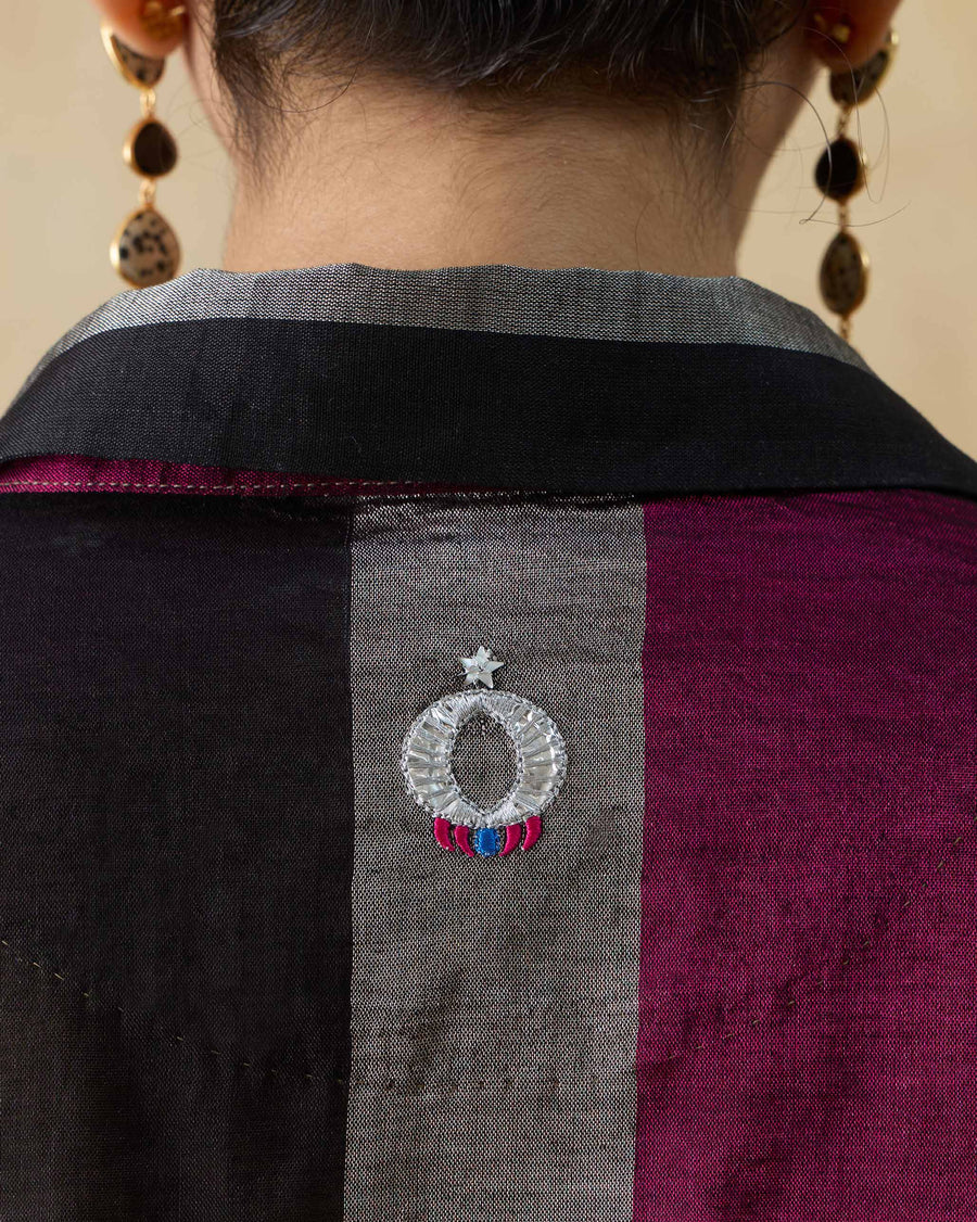 Close-up of the embroidered Anaar Patra below the collar at the back of the Firefly Shirt.