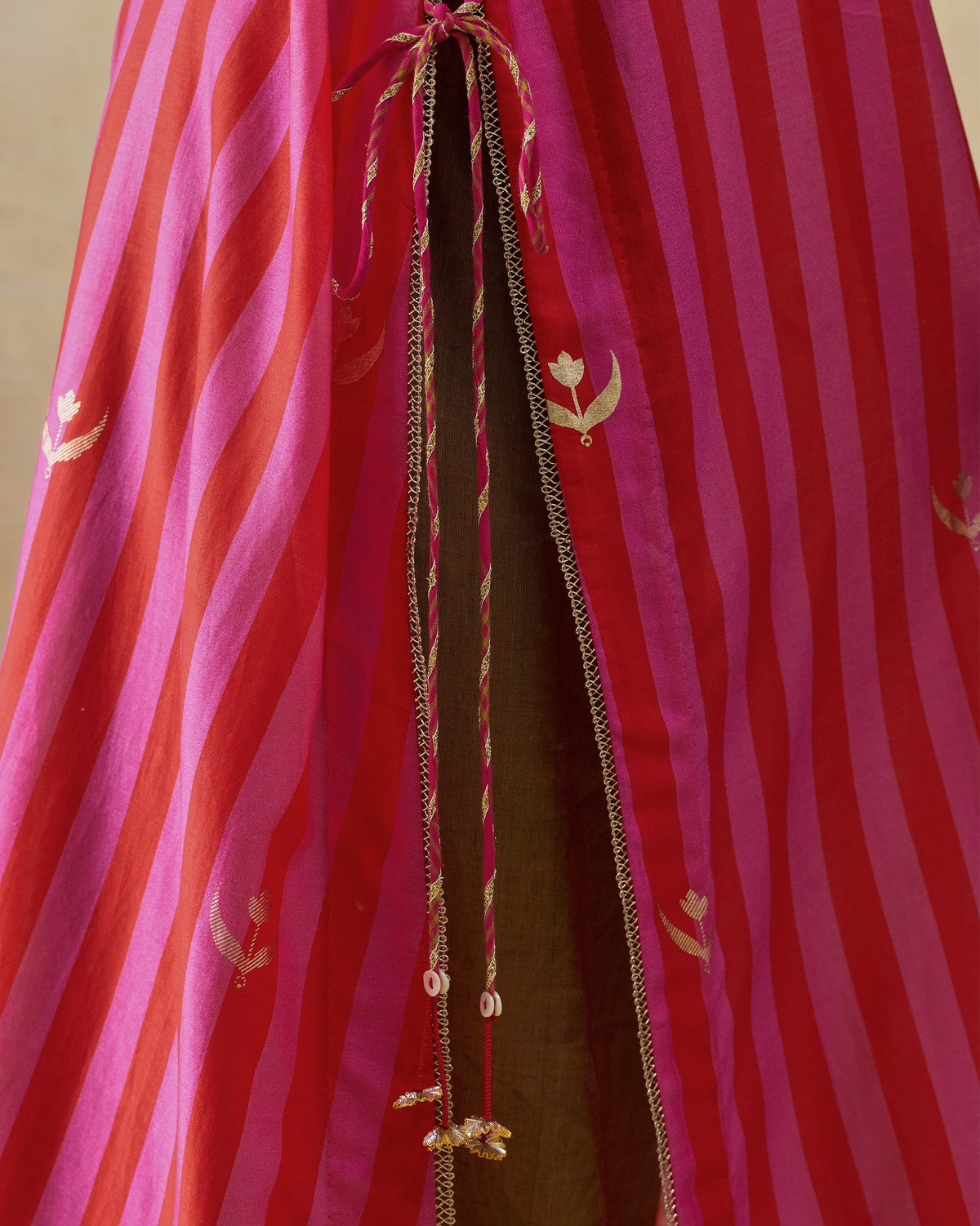 Close-up of the Galaxy kurta drawstring opening with gold tassels and foil motifs.