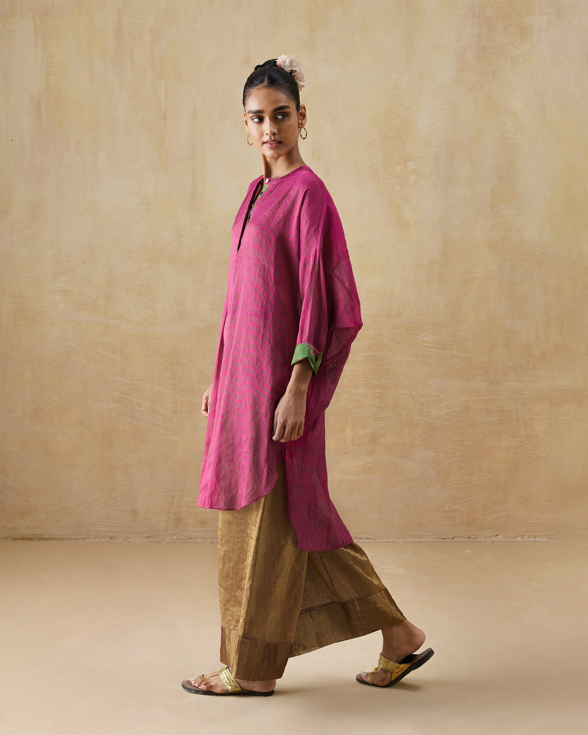Side view of a fuchsia and green Lazy Sunday tunic with a high-low hem.