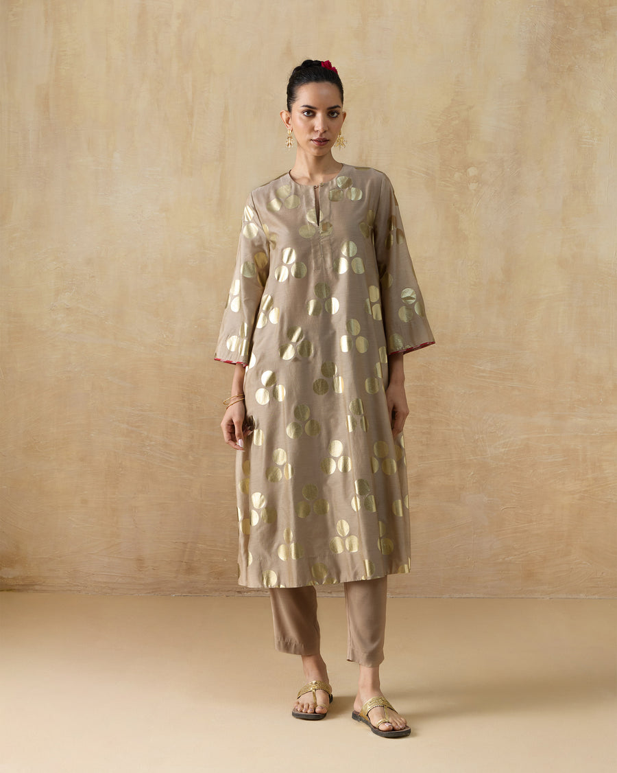 The Cloud Dancer Kurta, a long sand cotton silk A-line kurta with gold dots, worn over Narrow Pants.