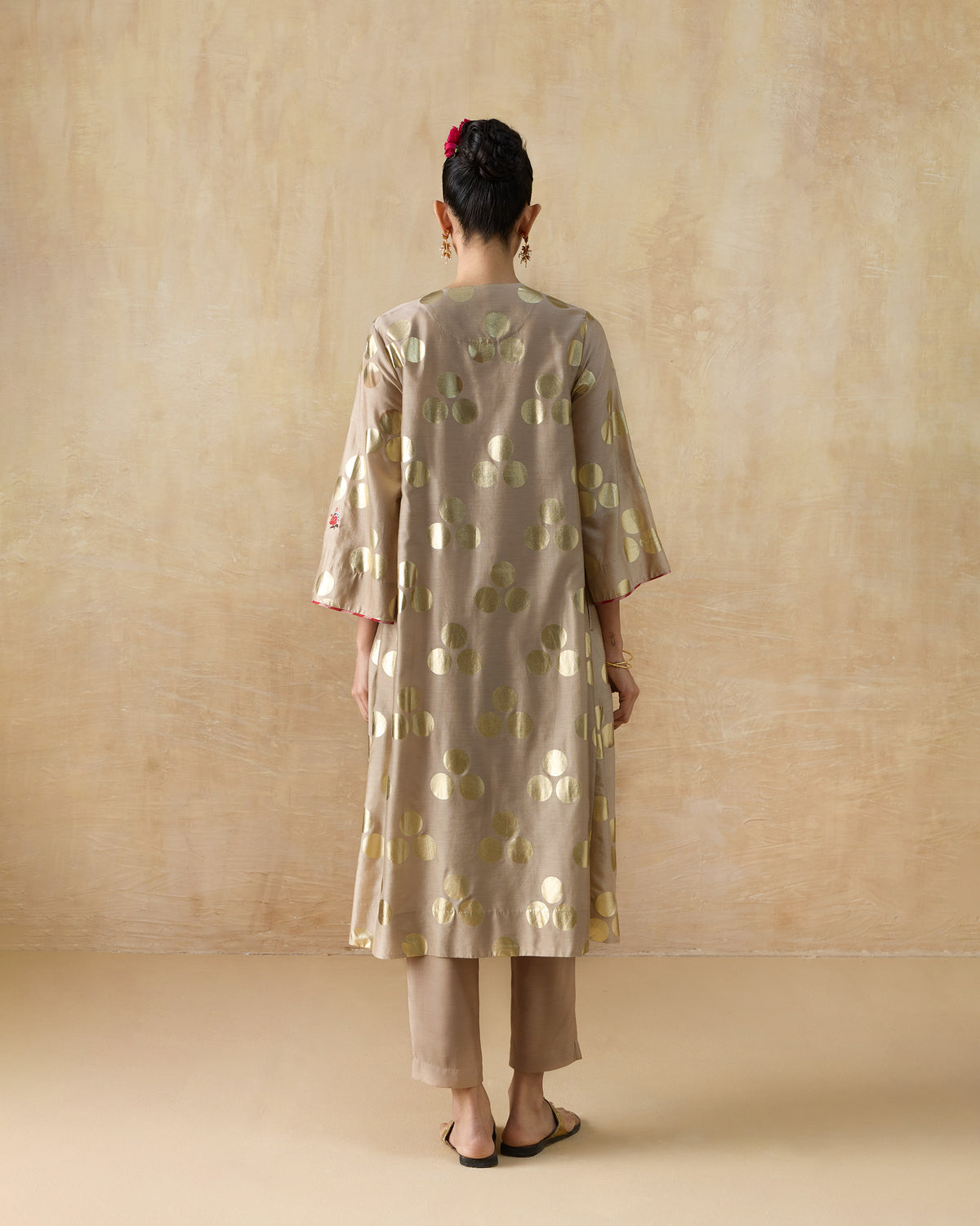 Back of a sand Cloud Dancer kurta with gold foil circle print.