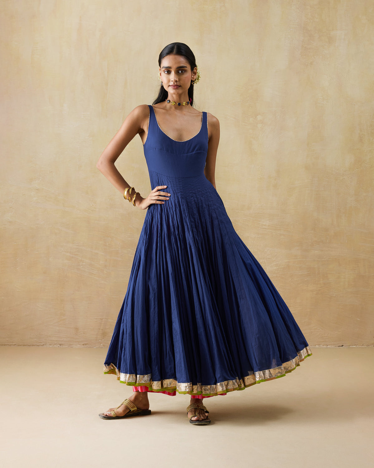 Front of a navy Kochi kurta with a deep U-neck and gold hem border.